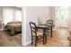 A quaint dining area, adjacent to the bedroom, features hardwood floors and a charming round table at 803 E 13Th St, Kannapolis, NC 28083