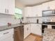 Bright kitchen features white cabinets, granite countertops, stainless steel appliances, and subway tile backsplash at 803 E 13Th St, Kannapolis, NC 28083