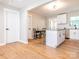 Open floor plan with island flowing into the kitchen, featuring granite countertops, white cabinets and stainless steel appliances at 803 E 13Th St, Kannapolis, NC 28083