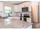 Bright, updated kitchen with white cabinets, granite countertops, and stainless steel appliances at 803 E 13Th St, Kannapolis, NC 28083