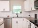 Modern kitchen featuring white cabinets, granite countertops, stainless steel appliances, and subway tile backsplash at 803 E 13Th St, Kannapolis, NC 28083