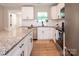 Modern kitchen with granite countertops, stainless steel appliances, white cabinets, hardwood floors, and a tile backsplash at 803 E 13Th St, Kannapolis, NC 28083