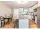 Well-lit kitchen featuring granite countertops, a central island with seating, and stainless steel appliances, and white cabinets at 803 E 13Th St, Kannapolis, NC 28083