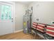 Functional laundry area with water heater, seating, and a door to the outside at 803 E 13Th St, Kannapolis, NC 28083
