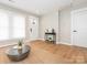 Bright living room with hardwood floors, neutral walls, large windows, and a stylish coffee table on a jute rug at 803 E 13Th St, Kannapolis, NC 28083