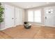 Bright living room with hardwood floors, neutral walls, large windows, a jute rug and white doors with black hardware at 803 E 13Th St, Kannapolis, NC 28083
