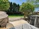 A serene backyard with a mix of stone and grass, surrounded by tall, mature trees at 8140 Laurel Run Dr, Charlotte, NC 28269