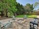 Backyard with a fire pit, chairs, and a landscaped area, ideal for outdoor relaxation and entertainment at 8140 Laurel Run Dr, Charlotte, NC 28269
