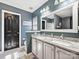 Well-appointed bathroom featuring a double sink vanity, granite countertops and a large mirror at 8140 Laurel Run Dr, Charlotte, NC 28269