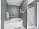 This bathroom features a soaking tub with a light blue accent rug, perfect for relaxing at 8140 Laurel Run Dr, Charlotte, NC 28269