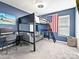 This bedroom is complete with a bunk bed with a futon, a desk, and blue walls, perfect for children at 8140 Laurel Run Dr, Charlotte, NC 28269
