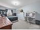 This bedroom is complete with a cozy bed, a desk, and light blue walls, perfect for relaxation at 8140 Laurel Run Dr, Charlotte, NC 28269