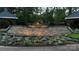 Elegant community entrance with stone walls, lush flower beds, and prominent signage, creating a welcoming and sophisticated atmosphere at 8140 Laurel Run Dr, Charlotte, NC 28269