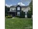 Charming two-story home with manicured lawn and vibrant landscaping, offering inviting curb appeal at 8140 Laurel Run Dr, Charlotte, NC 28269