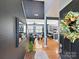 Bright foyer showcasing hardwood floors, modern lighting, and views into the living room and kitchen at 8140 Laurel Run Dr, Charlotte, NC 28269