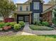 Inviting front entrance with colorful flower beds, a bench, and a charming front door at 8140 Laurel Run Dr, Charlotte, NC 28269
