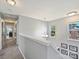 Bright hallway features neutral walls, lighting fixtures, and views to rooms and backyard at 8140 Laurel Run Dr, Charlotte, NC 28269