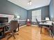 Spacious home office with hardwood floors, natural light, and a comfortable seating area at 8140 Laurel Run Dr, Charlotte, NC 28269
