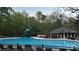 Large community pool with a slide, sun loungers, and a shaded pavilion, perfect for summer fun and relaxation at 8140 Laurel Run Dr, Charlotte, NC 28269