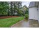 Lush backyard with manicured lawn and mature trees offers a private outdoor space at 942 Pelican Bay Dr, Pineville, NC 28134