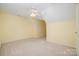 Spacious bedroom features neutral carpet, a ceiling fan, and neutral paint at 942 Pelican Bay Dr, Pineville, NC 28134