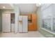 Bright kitchen features light wood cabinets, white appliances, and adjacent laundry area at 942 Pelican Bay Dr, Pineville, NC 28134