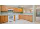 Well-lit kitchen with light wood cabinets, white appliances, and ample counter space at 942 Pelican Bay Dr, Pineville, NC 28134