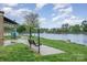 Scenic lake view with a swing bench and walking path at 942 Pelican Bay Dr, Pineville, NC 28134