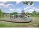 Playground featuring slides, swings, and climbing structures near a serene lake at 942 Pelican Bay Dr, Pineville, NC 28134