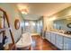 Relaxing primary bathroom with soaking tub and shower, double sink vanity and hardwood floors at 1009 Leigh Ave, Charlotte, NC 28205
