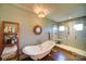 Relaxing primary bathroom with soaking tub and shower, double sink vanity and hardwood floors at 1009 Leigh Ave, Charlotte, NC 28205