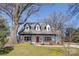 Charming home with large front porch and dormer windows, set against a clear blue sky at 1009 Leigh Ave, Charlotte, NC 28205