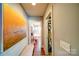 Hallway that provides views of the bathroom and walk-in closet with hardwood floors at 1009 Leigh Ave, Charlotte, NC 28205
