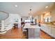 Bright, open kitchen featuring a large island with bar seating and modern lighting fixtures at 1009 Leigh Ave, Charlotte, NC 28205