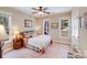 Bright bedroom with a cozy, colorful comforter, natural light, and a view to the outside at 1016 Secretariat Dr, York, SC 29745