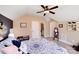 Bedroom featuring a ceiling fan, neutral walls, and views into the ensuite bathroom at 1016 Secretariat Dr, York, SC 29745