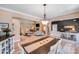 Open-concept dining room showcasing an expansive living room with a fireplace and neutral decor at 1016 Secretariat Dr, York, SC 29745