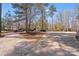 Long driveway and ample parking space surrounded by mature trees and a glimpse of the home at 1016 Secretariat Dr, York, SC 29745