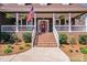 Inviting front porch showcasing a red door, white railings, and brick stairs at 1016 Secretariat Dr, York, SC 29745