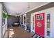 Cozy front porch featuring a red door, decorative accents, and a welcoming atmosphere at 1016 Secretariat Dr, York, SC 29745
