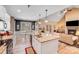 Open kitchen with a large island, stainless appliances, and views into the living room and dining area at 1016 Secretariat Dr, York, SC 29745