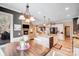 Open-concept kitchen with island, modern appliances, and a view into the living room and fireplace at 1016 Secretariat Dr, York, SC 29745