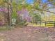 Scenic walking trail bordered by mature trees and a wooden fence at 1016 Secretariat Dr, York, SC 29745