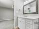Modern bathroom featuring a gray framed mirror and granite countertops at 102 Kerda St, Taylorsville, NC 28681