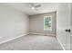 Bright bedroom featuring neutral walls, plush carpeting, a ceiling fan, and a window view at 102 Kerda St, Taylorsville, NC 28681