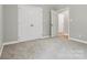 Cozy bedroom featuring neutral walls, plush carpeting, and a double door closet at 102 Kerda St, Taylorsville, NC 28681
