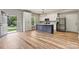 Bright, open kitchen with island, stainless steel appliances, modern finishes and wood floors at 102 Kerda St, Taylorsville, NC 28681