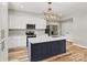 Renovated kitchen featuring a center island with granite countertops and stainless steel appliances at 102 Kerda St, Taylorsville, NC 28681