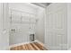 Convenient laundry room featuring vinyl flooring, shelving, and a utility closet at 102 Kerda St, Taylorsville, NC 28681