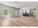 Open-concept living area with hardwood floors and a view of the updated kitchen at 102 Kerda St, Taylorsville, NC 28681